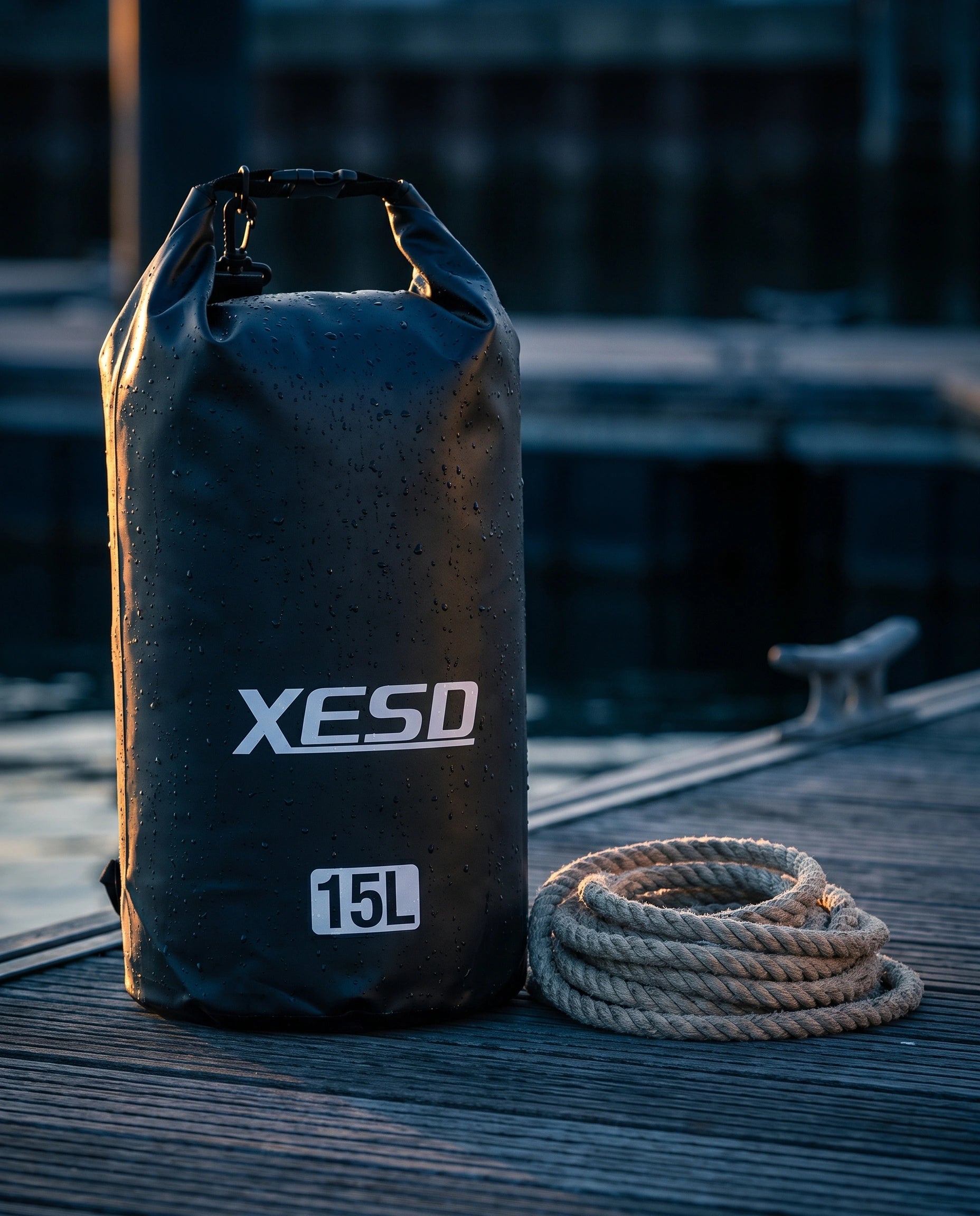 DryDock X-Series 15L Dry Bag in Black on a wooden boat dock at golden hour