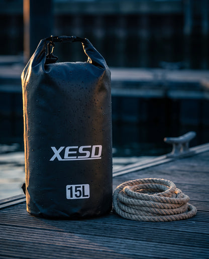 DryDock X-Series 15L Dry Bag in Black on a wooden boat dock at golden hour