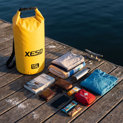 DryDock X-Series 15L Yellow Dry Bag with clothes, towel, water bottle, book and first aid kit it can carry