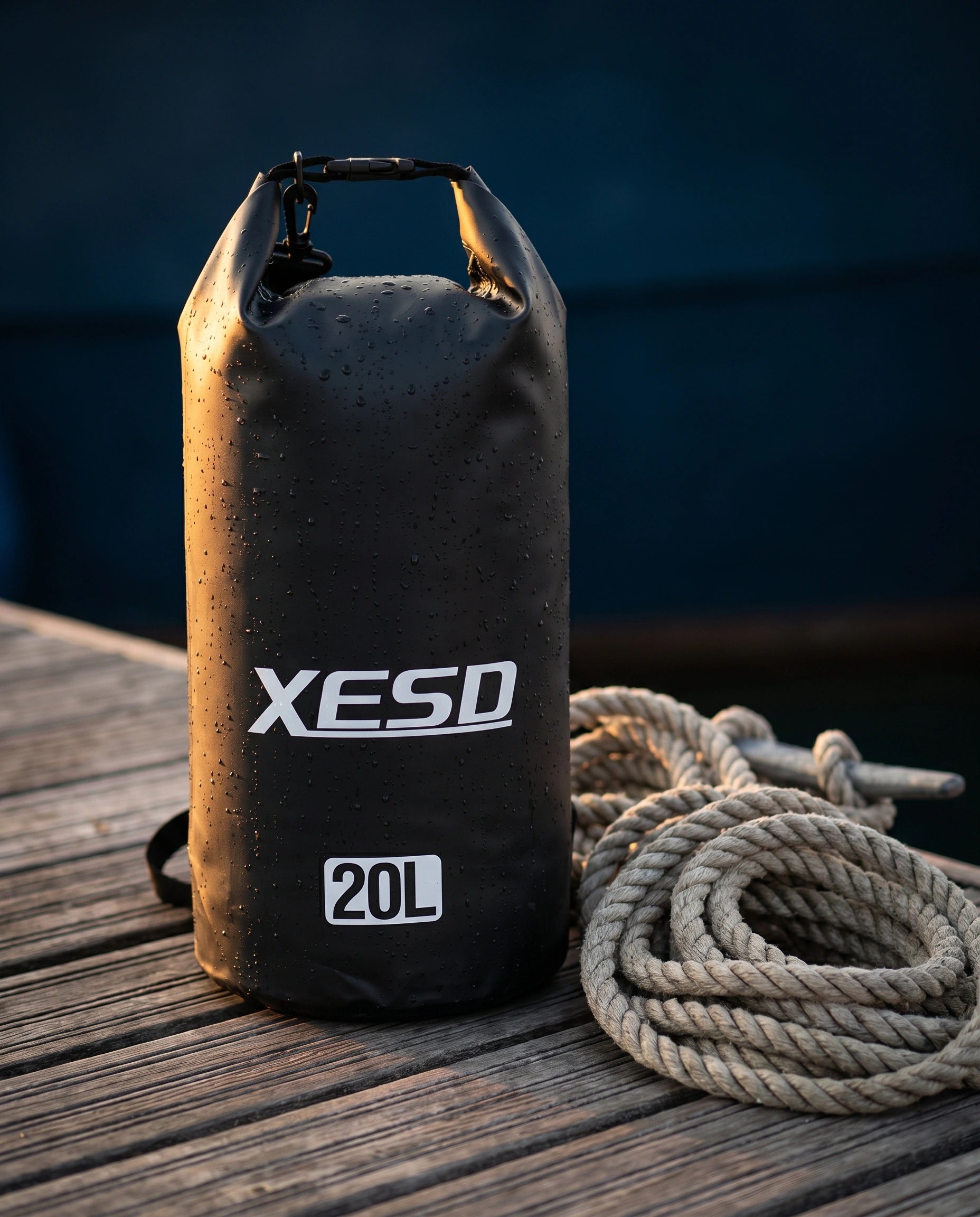 DryDock X-Series 20L Dry Bag in Black on a wooden boat dock at golden hour