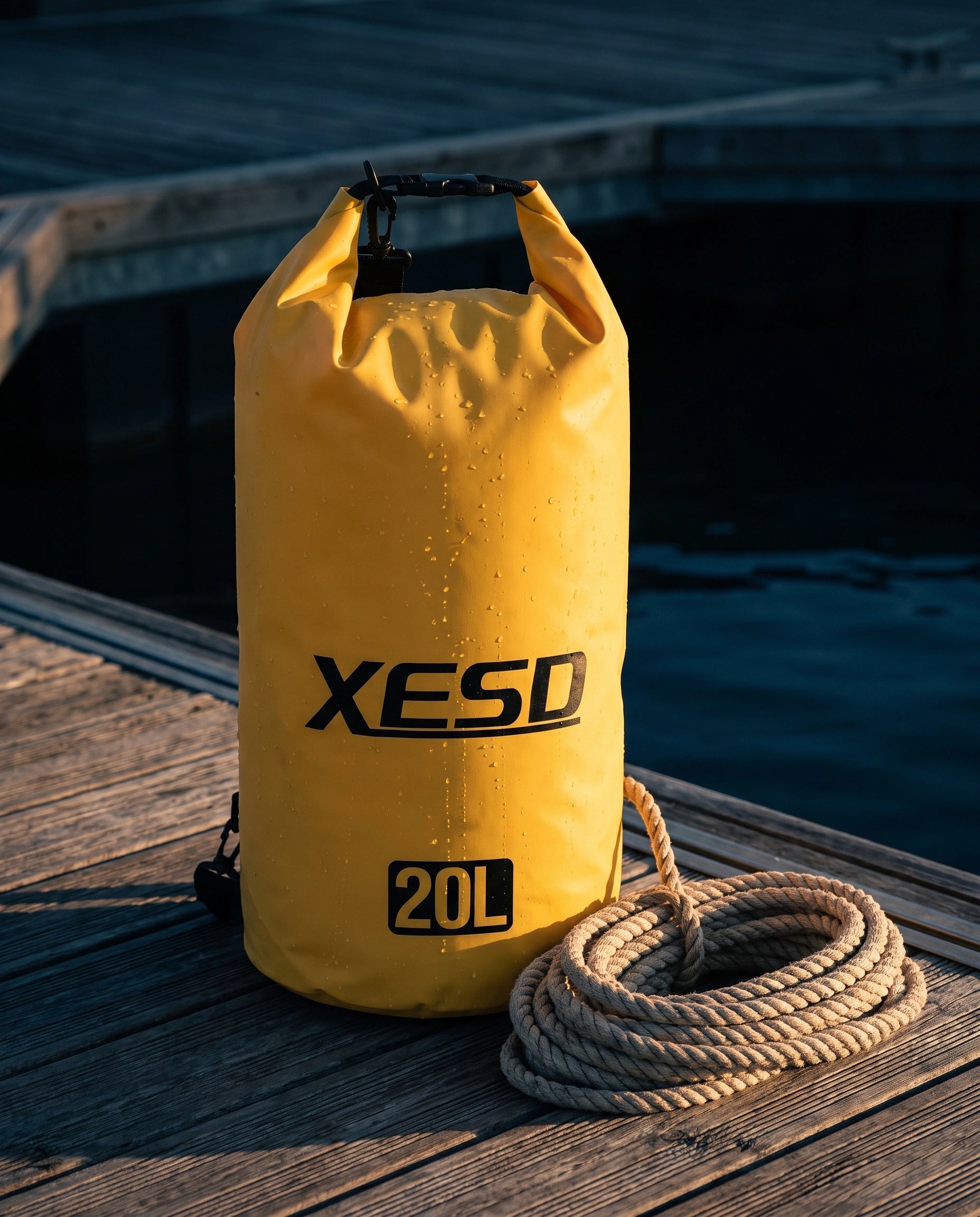DryDock X-Series 20L Dry Bag in Yellow on a wooden boat dock at golden hour