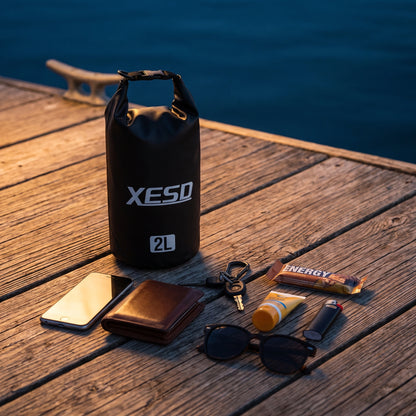 DryDock X-Series 2L Black Dry Bag with phone, wallet, keys, sunglasses and sunscreen it can carry