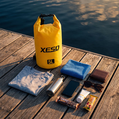 DryDock X-Series 5L Yellow Dry Bag with a t shirt, towel, water bottle and phone it can carry