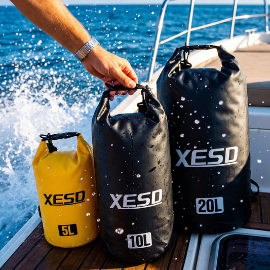 DryDock X-Series Dry Bag in black and yellow shown in a range of sizes on a boat deck, waterproof marine dry bag